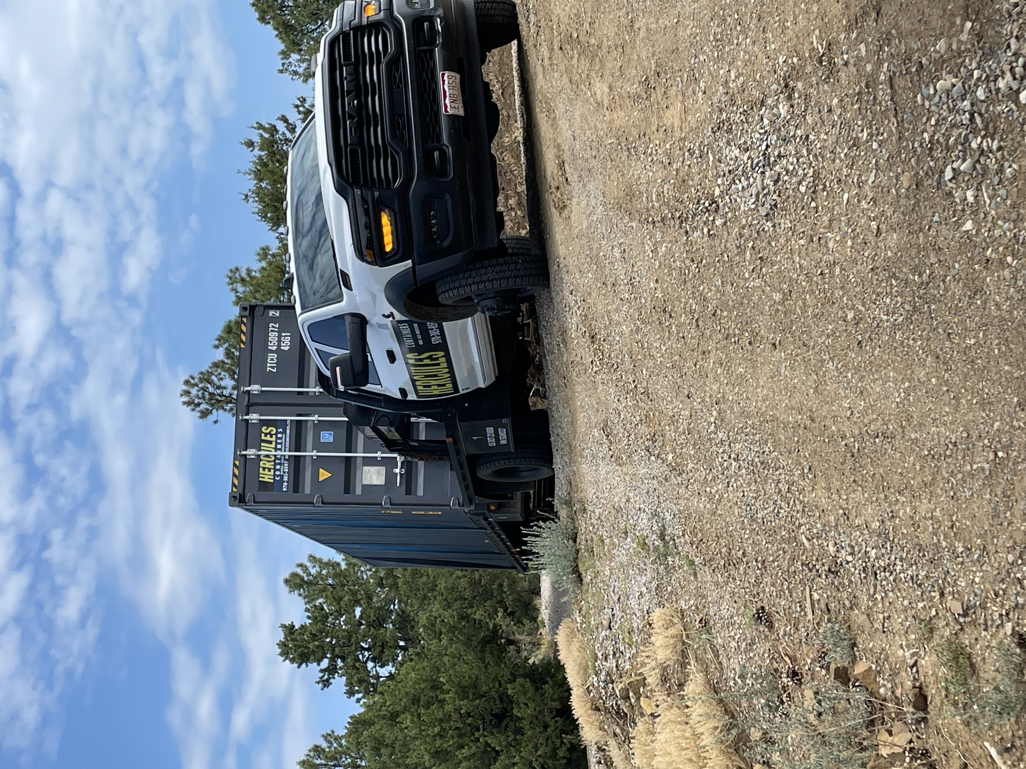 Container being loaded for transport by Hercules delivery truck