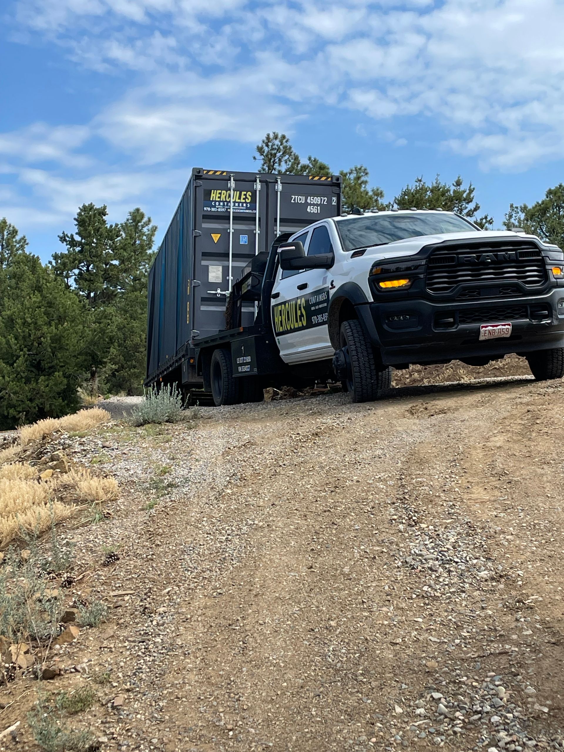 Container being relocated by delivery truck